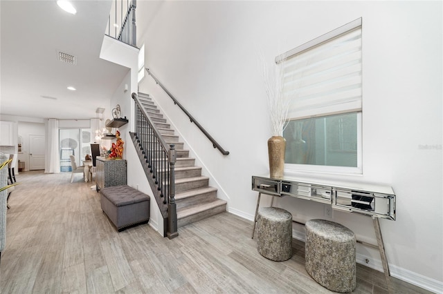 stairway featuring wood-type flooring