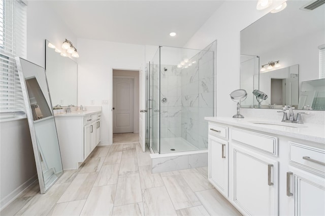 bathroom with vanity and a shower with door