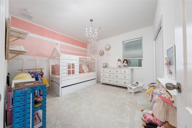 carpeted bedroom with an inviting chandelier