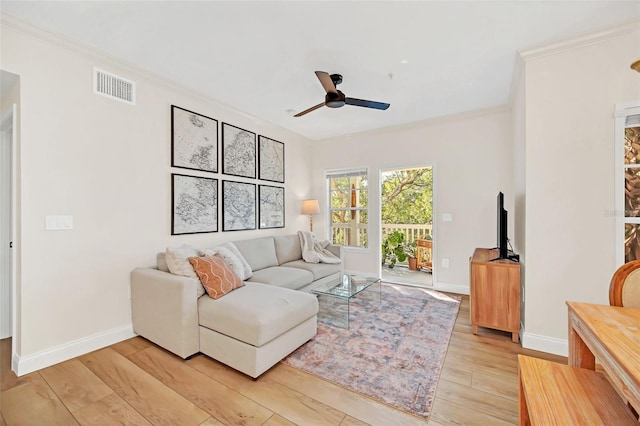 living room with light hardwood / wood-style floors, ceiling fan, and crown molding