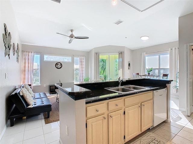 kitchen with ceiling fan, dishwasher, sink, a center island with sink, and light tile patterned floors