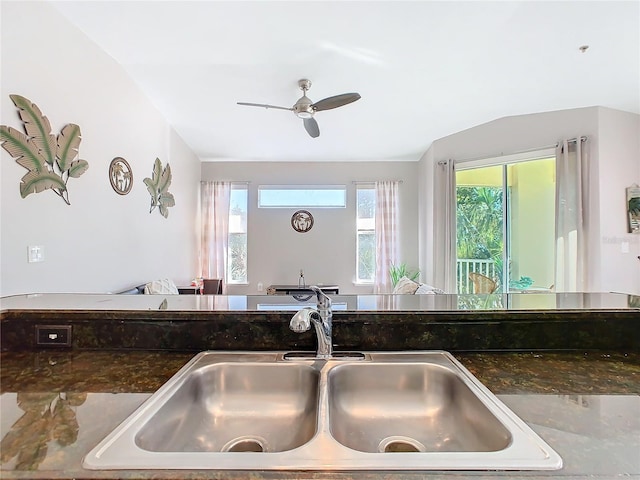 kitchen with plenty of natural light, ceiling fan, sink, and lofted ceiling