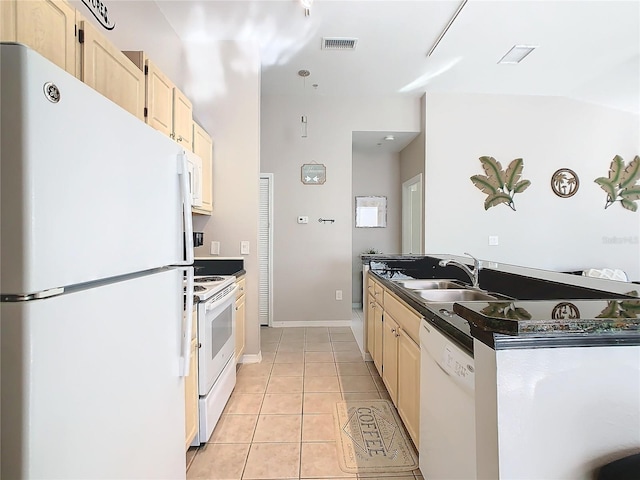 kitchen featuring lofted ceiling, white appliances, sink, light tile patterned floors, and light brown cabinetry