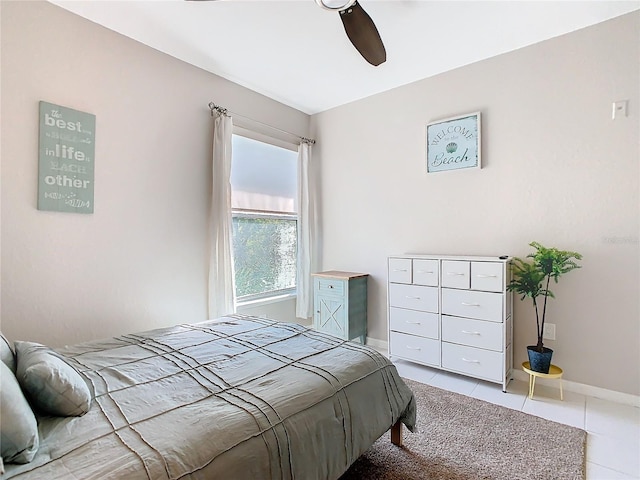 tiled bedroom featuring ceiling fan