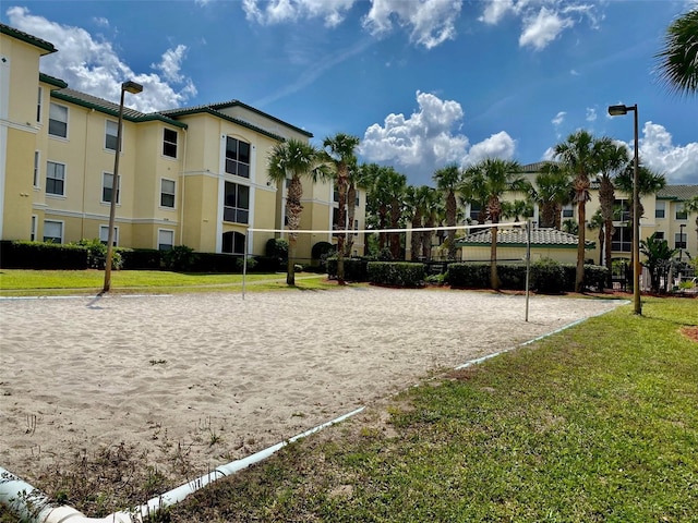 view of home's community featuring a yard and volleyball court