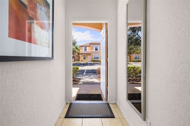 entryway with light tile patterned flooring