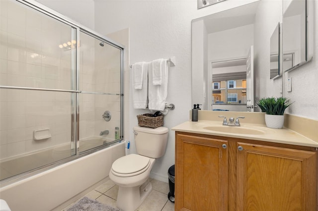 full bathroom with toilet, tile patterned floors, vanity, and shower / bath combination with glass door