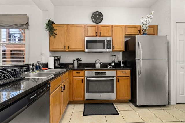 kitchen featuring sink, light tile patterned floors, and stainless steel appliances