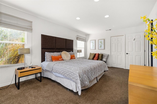 bedroom with carpet flooring and multiple windows