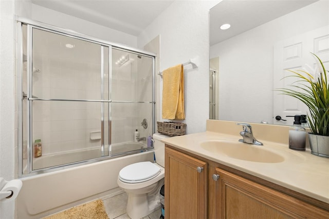 full bathroom with toilet, tile patterned flooring, enclosed tub / shower combo, and vanity