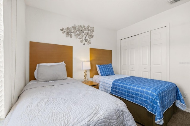 carpeted bedroom with a closet