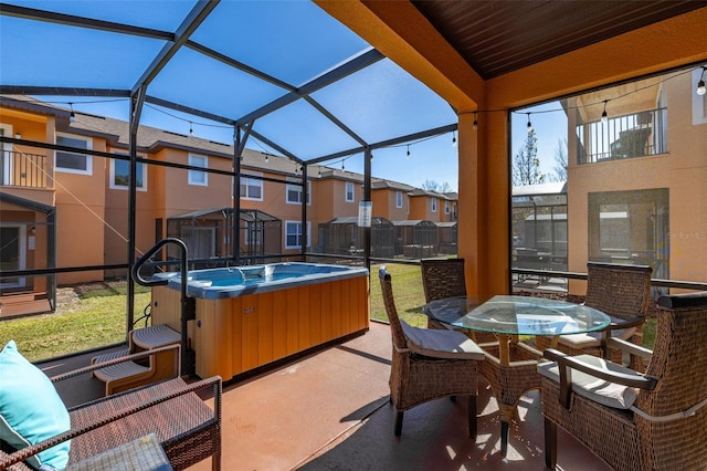 view of patio featuring a lanai and a hot tub