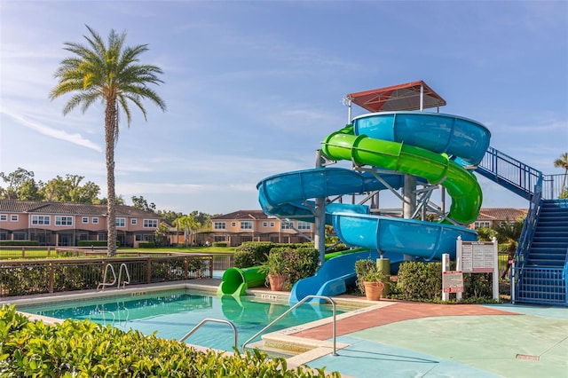 view of swimming pool with a water slide