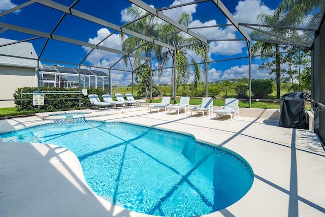 view of swimming pool with a patio area, an in ground hot tub, and glass enclosure