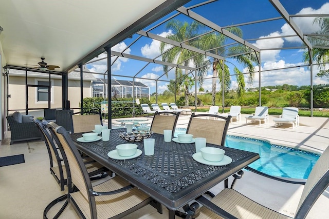 view of patio featuring ceiling fan and a lanai