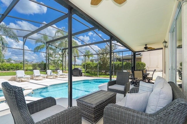 view of pool with a patio area and glass enclosure