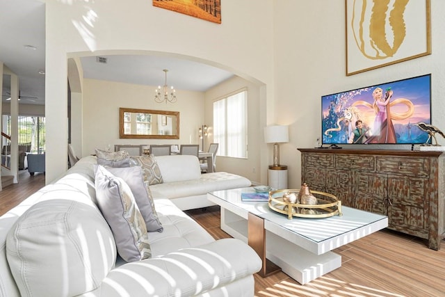 living room with hardwood / wood-style floors and an inviting chandelier