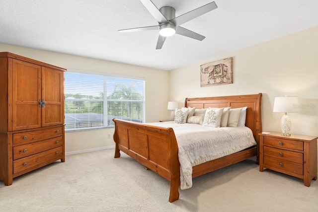 bedroom featuring ceiling fan and light colored carpet