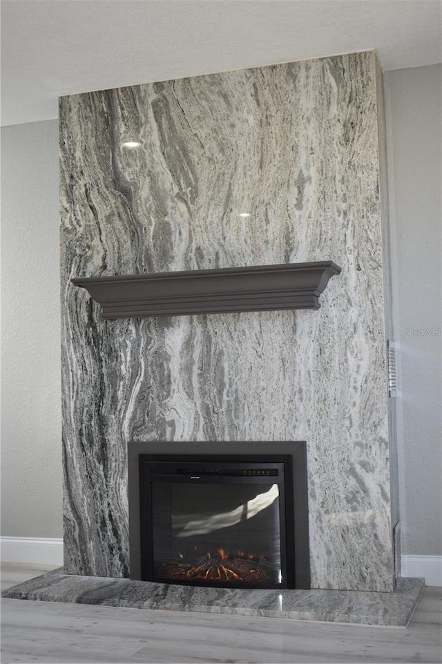 interior details featuring a fireplace and hardwood / wood-style flooring