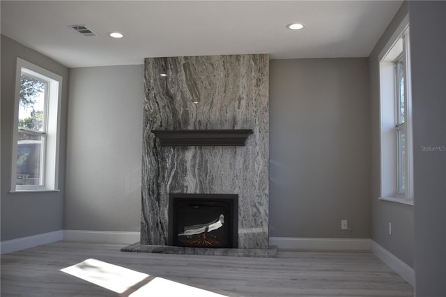 unfurnished living room with a fireplace and light hardwood / wood-style flooring