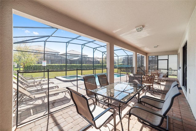 view of patio with a swimming pool with hot tub and a lanai