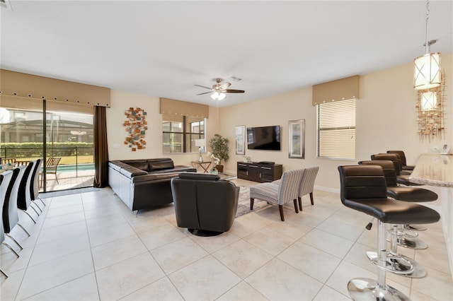 tiled living room with a wealth of natural light and ceiling fan