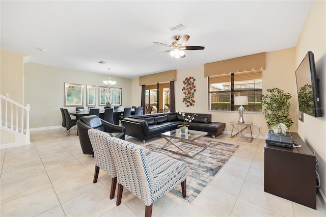 living room featuring light tile patterned floors and ceiling fan with notable chandelier