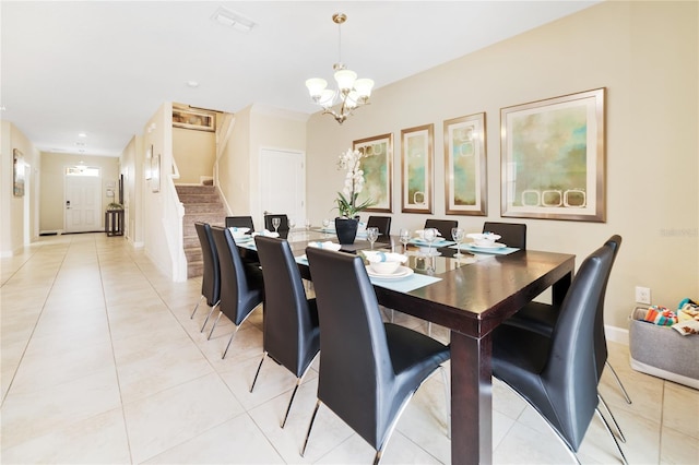 tiled dining area featuring a notable chandelier