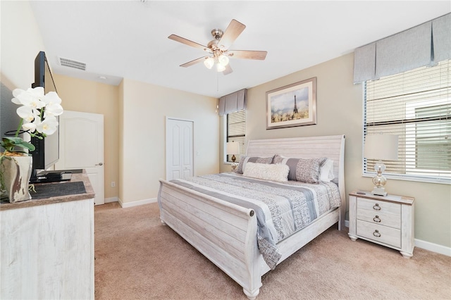 carpeted bedroom with a closet and ceiling fan