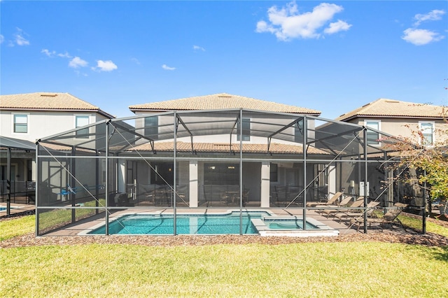 rear view of house featuring glass enclosure, a yard, a patio, and a pool with hot tub