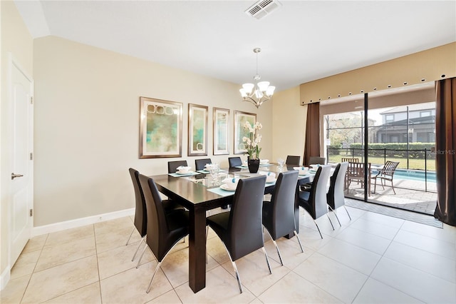 tiled dining space featuring an inviting chandelier and lofted ceiling