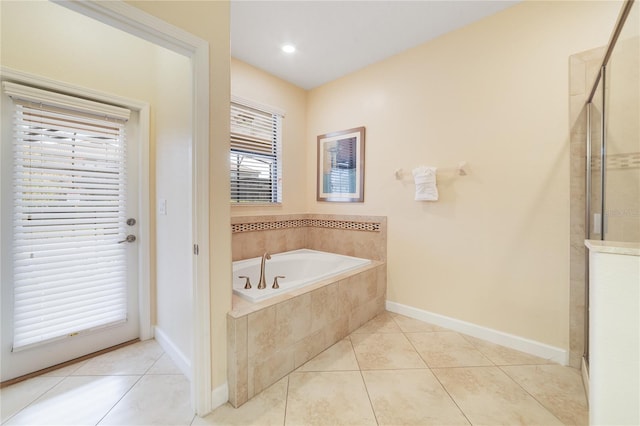 bathroom with tile patterned floors and independent shower and bath