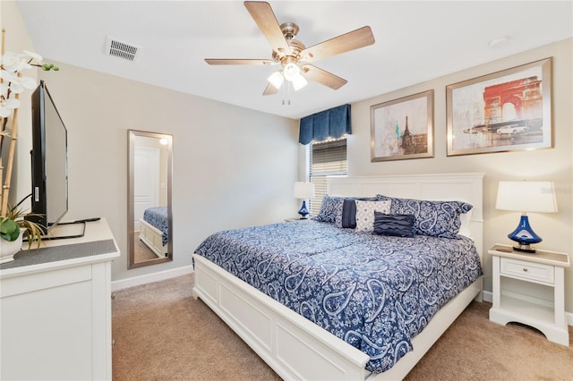 bedroom featuring light colored carpet and ceiling fan