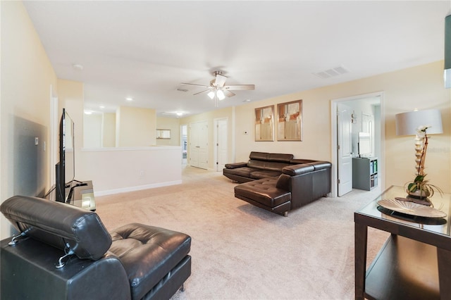 living room featuring ceiling fan and light carpet