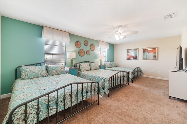 bedroom featuring ceiling fan and light carpet