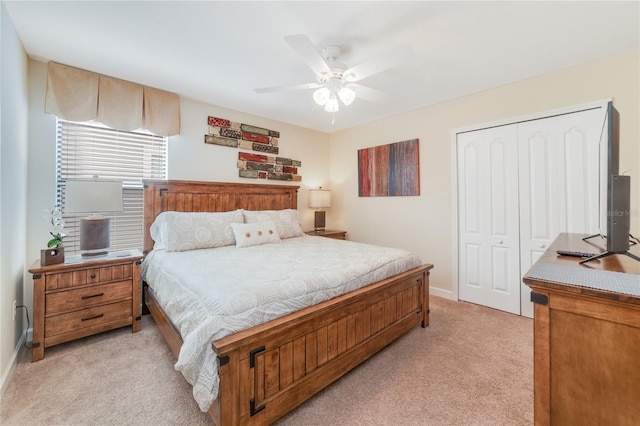 bedroom with light carpet, a closet, and ceiling fan