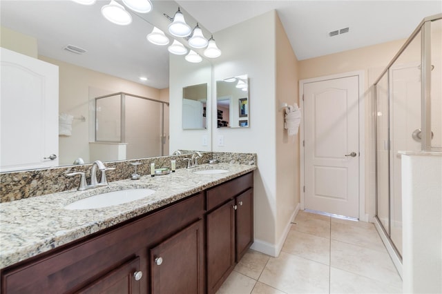 bathroom featuring tile patterned flooring, vanity, and an enclosed shower