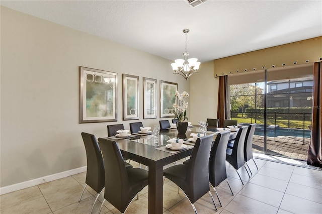 dining space featuring light tile patterned floors and a chandelier