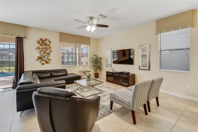 living room with ceiling fan and light tile patterned floors