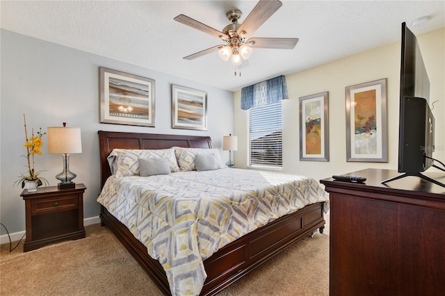 carpeted bedroom featuring ceiling fan and a textured ceiling