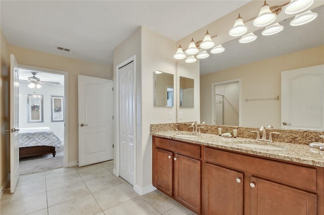 bathroom with tile patterned flooring, vanity, and ceiling fan