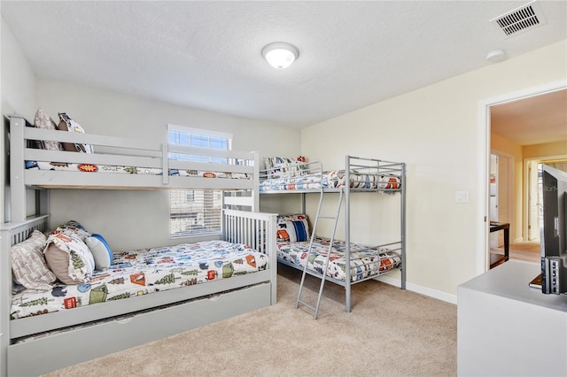 carpeted bedroom featuring a textured ceiling