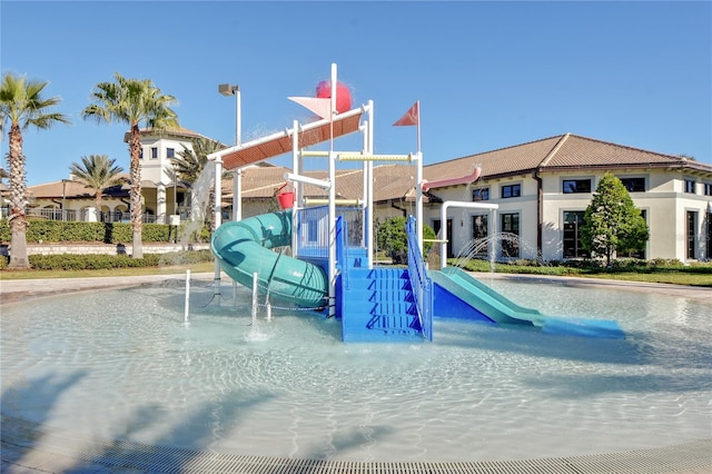 exterior space with a playground and a water slide