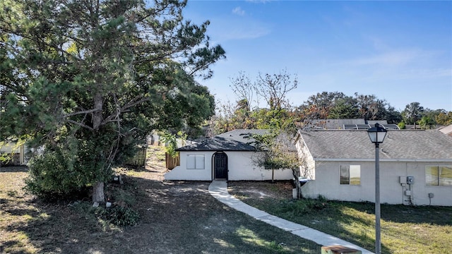 view of side of home with a yard