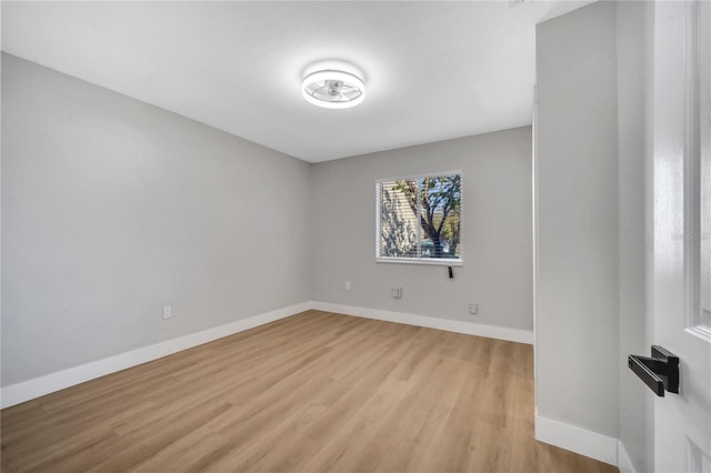 empty room with light hardwood / wood-style flooring