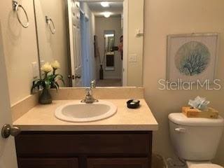 bathroom featuring vanity and toilet