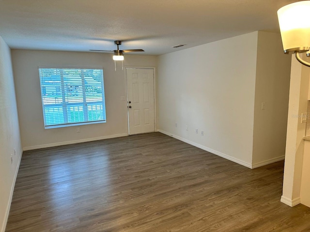 spare room featuring a textured ceiling, dark hardwood / wood-style flooring, and ceiling fan