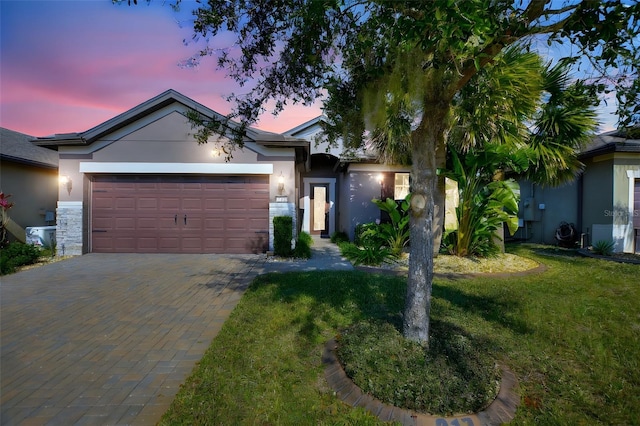 single story home featuring a yard and a garage