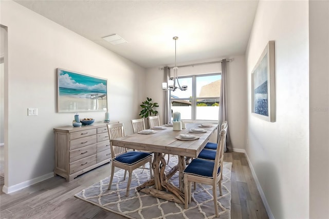 dining space featuring a chandelier and light hardwood / wood-style floors