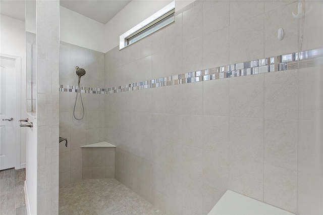 bathroom featuring a tile shower